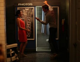 Couple looking at photos from a photobooth
