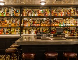Photo of wall of bottles behind the bar
