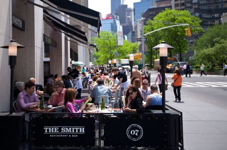 Exterior photo of The Smith Lincoln Square outdoor cafe filled with guests