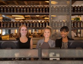 Photo of smiling staff behind a counter