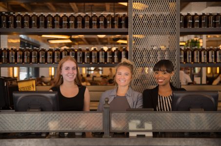 Photo of smiling staff behind a counter