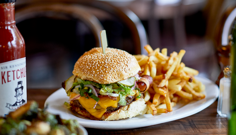 Photo of a cheese burger and fries on a plate