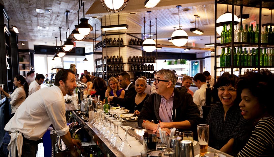 A photo of The Smith Lincoln Square's bar area filled with people